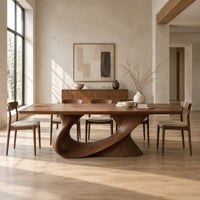 Dining table on a single sweeping pedestal with an oval opening in a bright open plan dining room