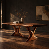 Dining table with two branching legs and a wavy edged top, three-quarter view showing the grain