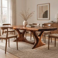Dining table with two branching legs and a wavy edged top in a Scandinavian dining room with white walls