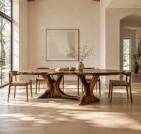 Dining table with two branching legs and a wavy edged top in a bright open plan dining room