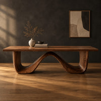 Dining table on a continuous double wave base with a smooth plank top in a dark studio against a charcoal plaster wall