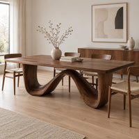 Dining table on a continuous double wave base with a smooth plank top in a Scandinavian dining room with white walls