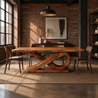 Rectangular dining table with a thick plank top on a sculpted loop base in an industrial loft dining room with exposed brick