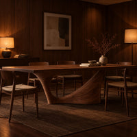 Long dining table on a single swept pedestal with an open arch in an evening dining room with walnut wall paneling