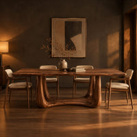 Dining table with a smooth top on an open u frame base in a dark dining room at golden hour