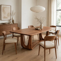 Dining table with a smooth top on an open u frame base in a Scandinavian dining room with white walls