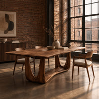 Dining table with a smooth top on an open u frame base in an industrial loft dining room with exposed brick