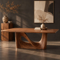 Corner detail of dining table with a smooth rectangular top and a wave sculpted base beside wood, brass and linen samples