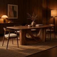 Dining table with a smooth rectangular top and a wave sculpted base in an evening dining room with walnut wall paneling