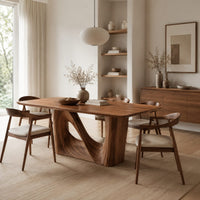 Dining table with a smooth rectangular top and a wave sculpted base in a Scandinavian dining room with white walls