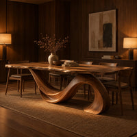 Dining table with a single sweeping wave base under a long slab top in an evening dining room with walnut wall paneling