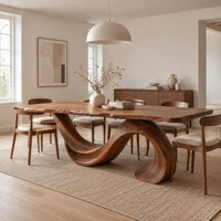 Dining table with a single sweeping wave base under a long slab top in a Scandinavian dining room with white walls