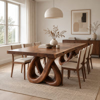 Dining table with two knotted loop pedestals and a thick slab top in a Scandinavian dining room with white walls