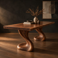 Dining table with two sculpted pedestal legs and a thick flat top, three-quarter view showing the grain
