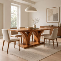 Rectangular dining table with two flared pedestals on a shared low plinth in a Scandinavian dining room with white walls