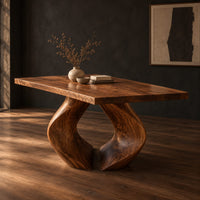Rectangular dining table on two sculpted legs that form a teardrop gap, three-quarter view showing the grain