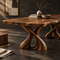 Corner detail of dining table with two twisted pedestals and a live edge top beside wood, brass and linen samples