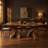 Dining table with two twisted pedestals and a live edge top in a dark dining room at golden hour