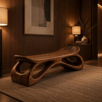 Bench with a dished seat and sculpted legs with oval cutouts in an evening entryway with walnut wall paneling
