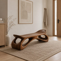 Bench with a dished seat and sculpted legs with oval cutouts in a Scandinavian entryway with white walls
