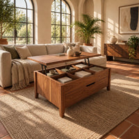 Rectangular lift top coffee table with divided compartments and tapered legs in a bright living room with arched windows and plants