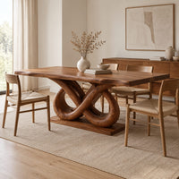 Dining table with a wavy edged slab top and a double infinity loop base in a Scandinavian dining room with white walls