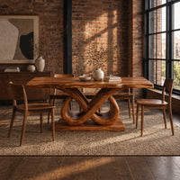 Dining table with a wavy edged slab top and a double infinity loop base in an industrial loft dining room with exposed brick