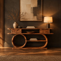 Console table with a double loop base and two small drawers in a dark entryway at golden hour