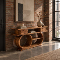 Console table with a double loop base and two small drawers in an industrial loft entryway with exposed brick