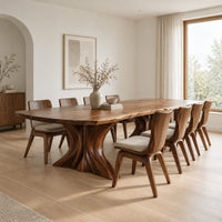 Dining table with a long top and two flared sculpted pedestals in a Scandinavian dining room with white walls