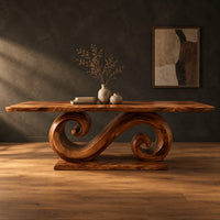 Dining table with a double scroll pedestal on a flat plinth in a dark studio against a charcoal plaster wall