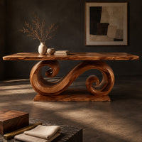Corner detail of dining table with a double scroll pedestal on a flat plinth beside wood, brass and linen samples