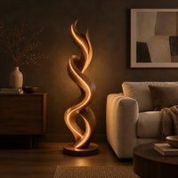Twisting double ribbon floor lamp with a warm glow in a dark living room at golden hour