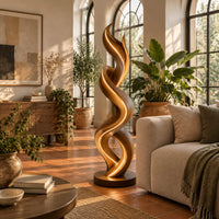 Twisting double ribbon floor lamp with a warm glow in a bright living room with arched windows and plants