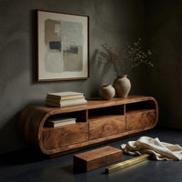 Corner detail of drawer TV console with a column of curled shelves beside wood, brass and linen samples