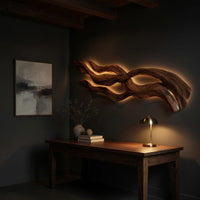 Streaming strands driftwood style wall sculpture above a desk in a dark study corner