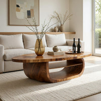 Oval coffee table on a drum base with an open shelf in an open plan space in daylight