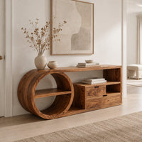 Console table with a drum shaped shelf end, two drawers and an open cubby in a Scandinavian entryway with white walls