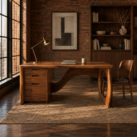 Executive desk with oval ring leg and curved back panel in an industrial loft home office with exposed brick