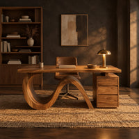 Desk with a looping wave base and a drawer pedestal in a dark home office at golden hour