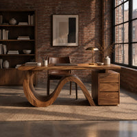 Desk with a looping wave base and a drawer pedestal in an industrial loft home office with exposed brick