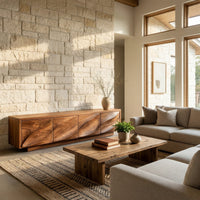 TV cabinet with four faceted sculpted doors in an open plan space in daylight