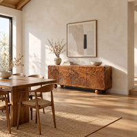 Sideboard carved with fan shaped leaves on four doors and ball feet in a bright open plan dining room