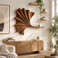 Fan shaped leaf wall art with carved ribs and a small ledge in a bright sunroom with green plants