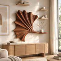 Fan shaped leaf wall art with carved ribs and a small ledge above a light oak sideboard in daylight