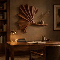 Fan shaped leaf wall art with carved ribs and a small ledge above a desk in a dark study corner