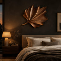 Fan shaped wooden leaf with raised ribs and a ruffled edge above a bed in a dusk lit bedroom