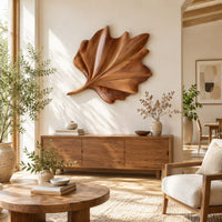 Fan shaped wooden leaf with raised ribs and a ruffled edge in a bright sunroom with green plants