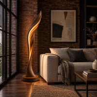 Tall twisting floor lamp shaped like a leaf with a glowing seam in an industrial loft living room with exposed brick