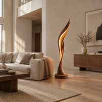 Tall twisting floor lamp shaped like a leaf with a glowing seam in a bright open plan living room